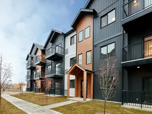 Modern multi-family exterior in charcoal and wood tones