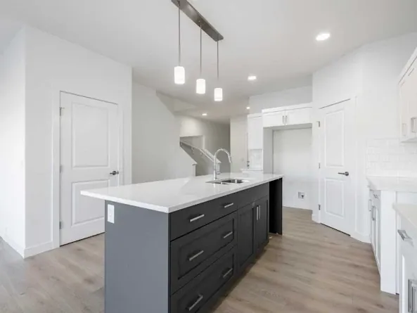 Two-tone kitchen with charcoal island and white walls